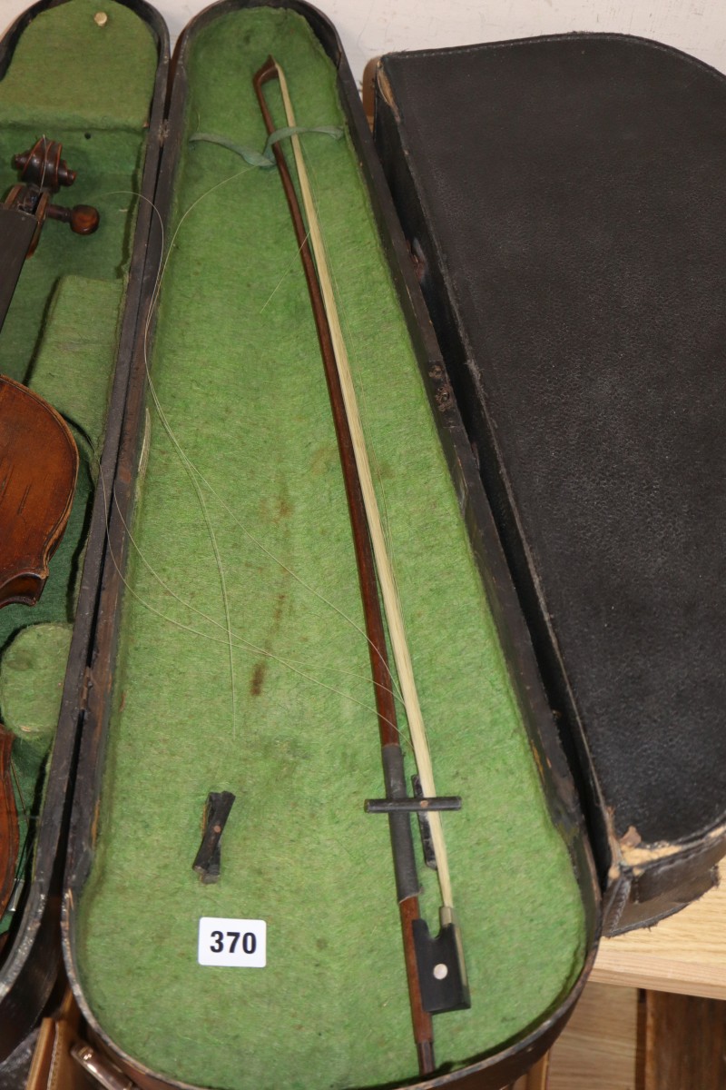 An early 20th century Saxon violin cased with bow and a cased banjo